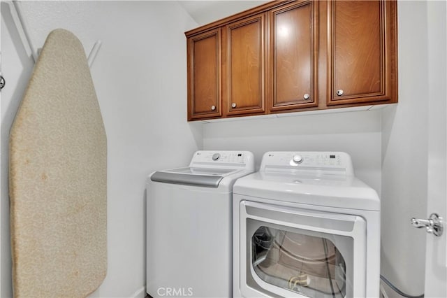 laundry area featuring cabinet space and washing machine and clothes dryer