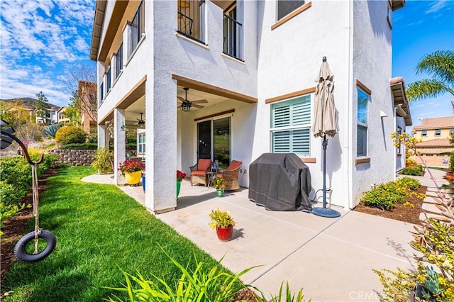 exterior space with grilling area and a ceiling fan