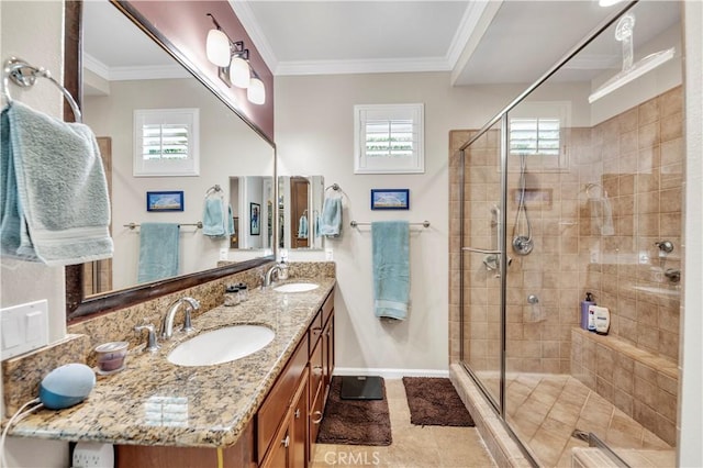 full bath featuring ornamental molding, a sink, and a shower stall