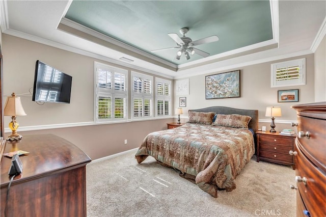 bedroom featuring a ceiling fan, baseboards, ornamental molding, carpet, and a raised ceiling