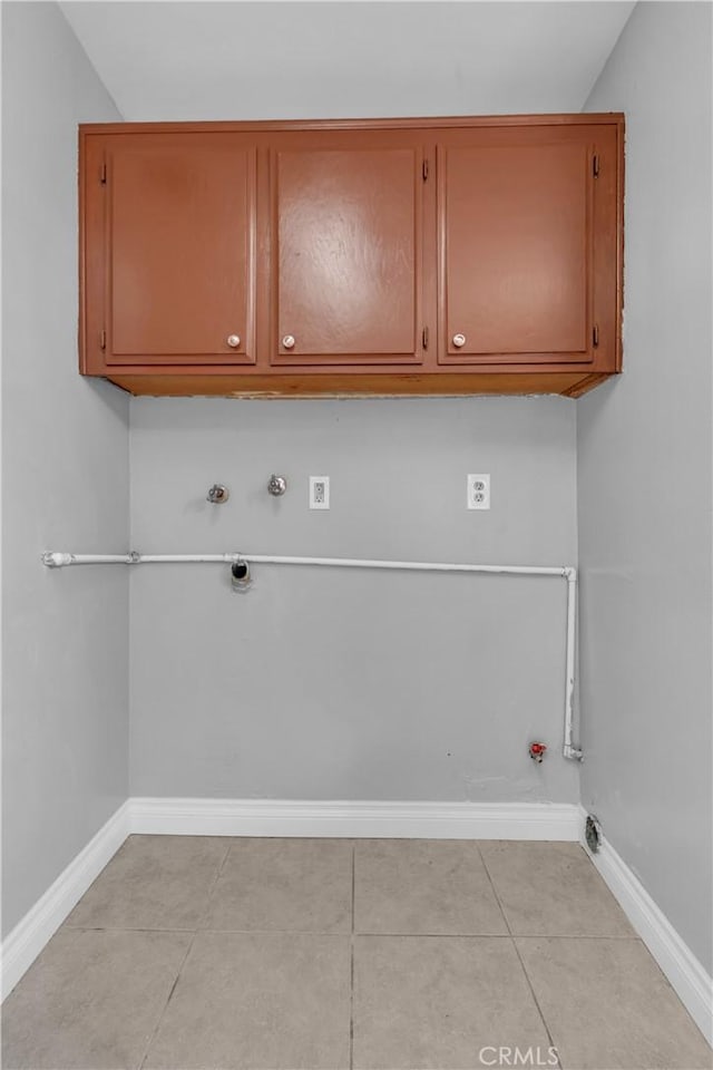 washroom with cabinet space, baseboards, gas dryer hookup, hookup for a washing machine, and electric dryer hookup