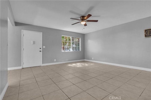 empty room with baseboards and a ceiling fan