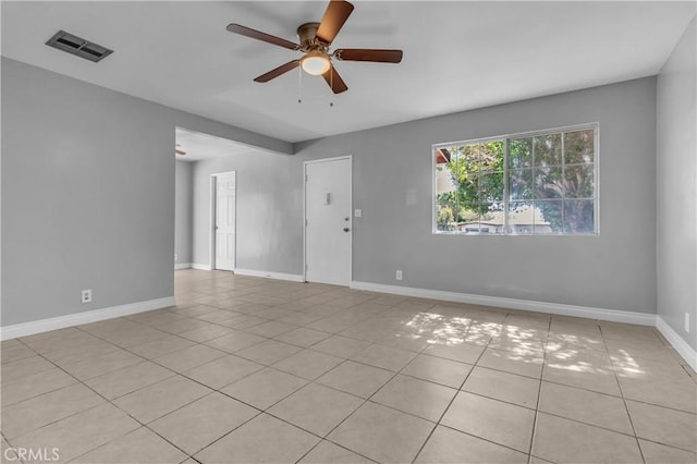 unfurnished room with visible vents, ceiling fan, baseboards, and light tile patterned flooring