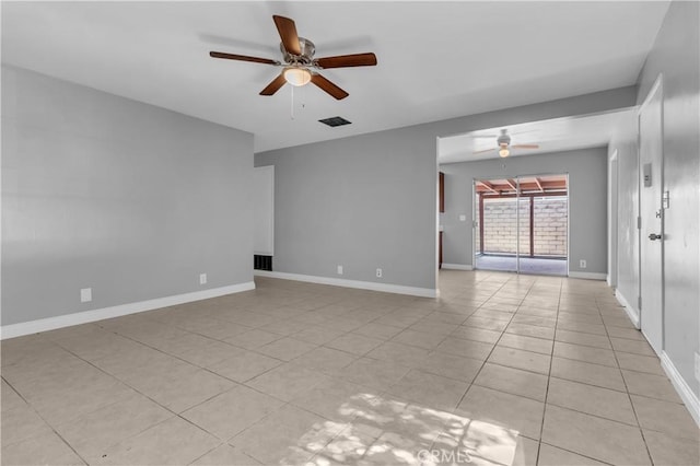 empty room with visible vents, ceiling fan, baseboards, and light tile patterned flooring