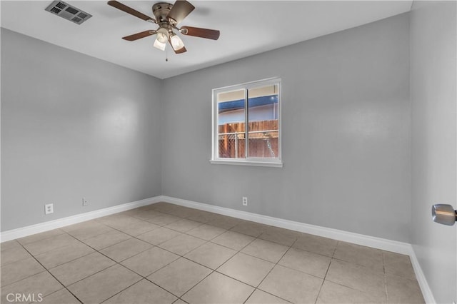 unfurnished room featuring light tile patterned floors, baseboards, visible vents, and a ceiling fan