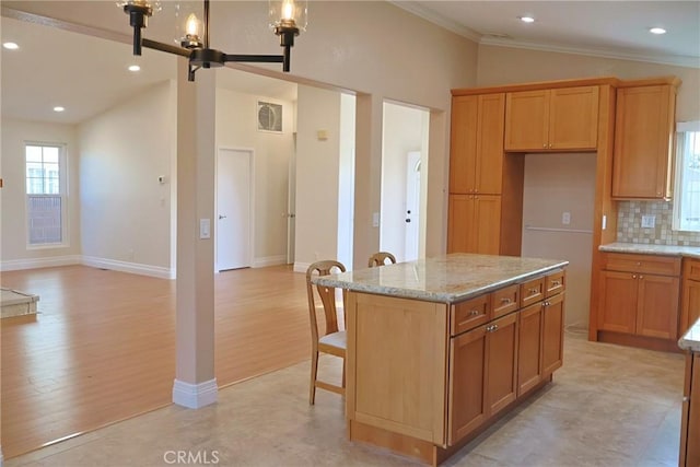 kitchen with tasteful backsplash, visible vents, lofted ceiling, light stone counters, and a kitchen breakfast bar