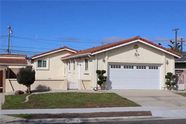 view of front of home featuring a garage, driveway, a tiled roof, and stucco siding