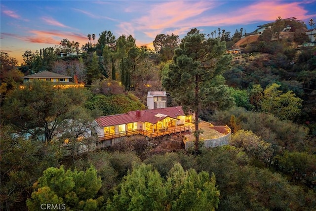 drone / aerial view with a wooded view