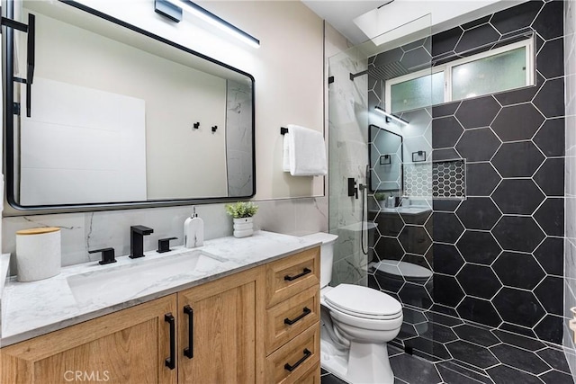 bathroom with toilet, walk in shower, and vanity