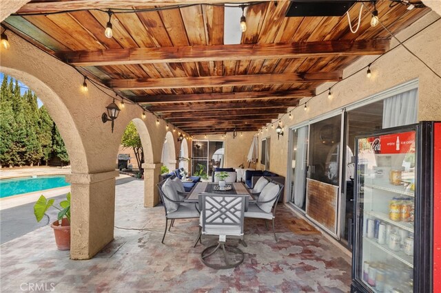 view of patio featuring outdoor dining area and an outdoor pool