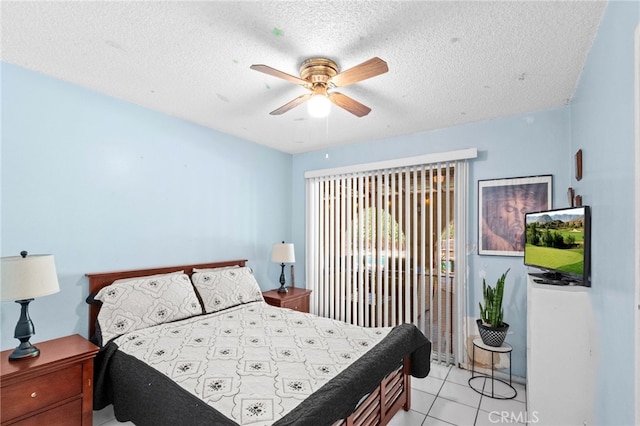 bedroom with access to outside, ceiling fan, a textured ceiling, and light tile patterned floors