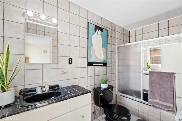 bathroom featuring tasteful backsplash, tile walls, and vanity