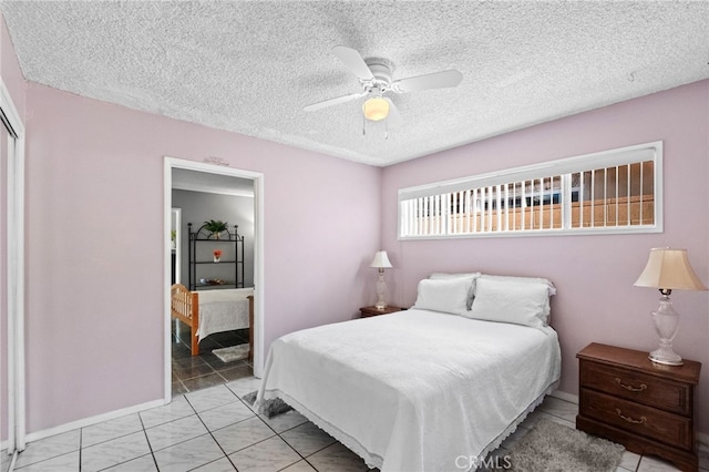 bedroom with light tile patterned floors, a ceiling fan, and a textured ceiling