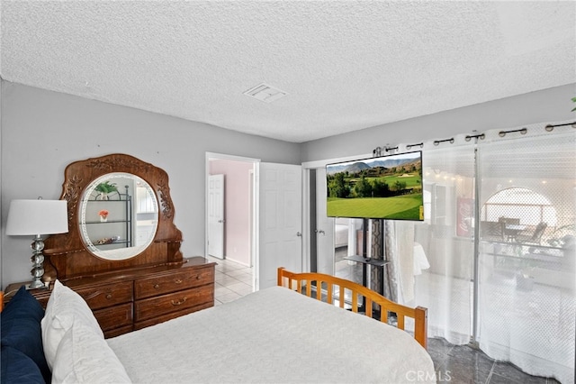 tiled bedroom with multiple windows, visible vents, and a textured ceiling