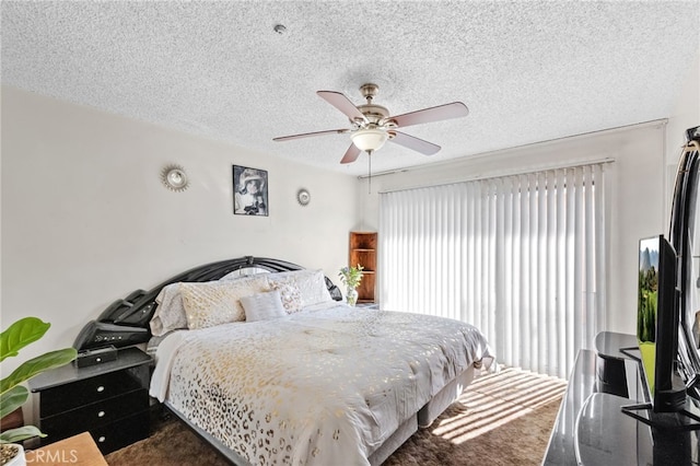 bedroom featuring a ceiling fan and a textured ceiling