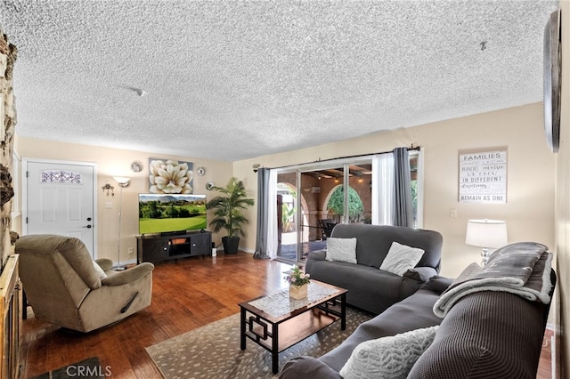 living area featuring a textured ceiling and wood finished floors