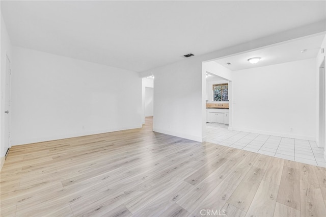 empty room with visible vents and light wood-style floors