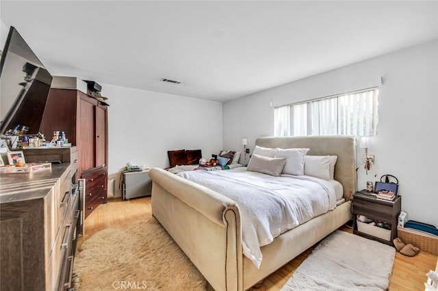 bedroom featuring visible vents and light wood-style flooring