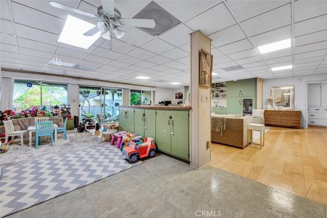 game room featuring ceiling fan and a drop ceiling