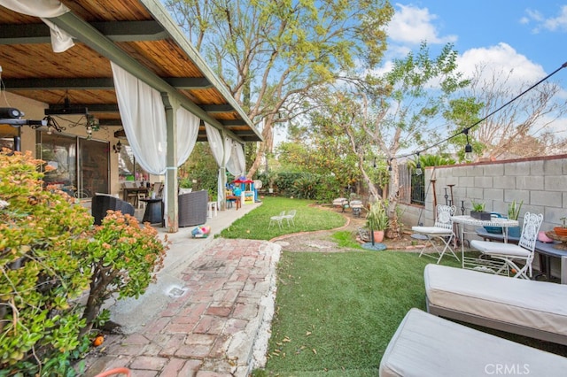 view of yard featuring a patio area and fence