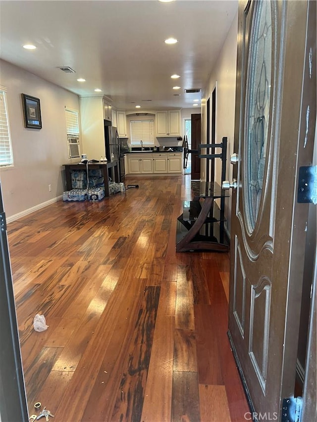 exercise area featuring visible vents, baseboards, dark wood-style flooring, and recessed lighting