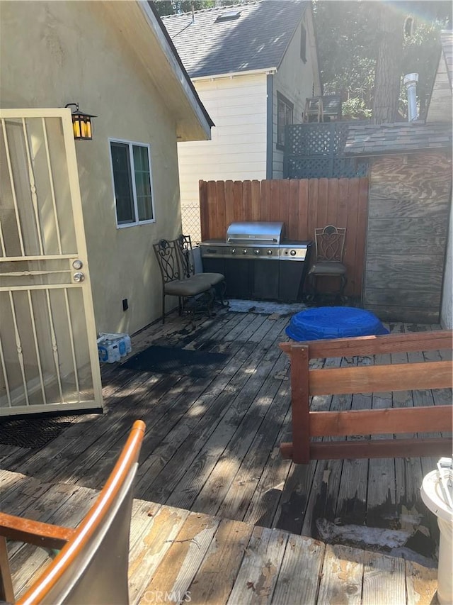 wooden terrace featuring fence