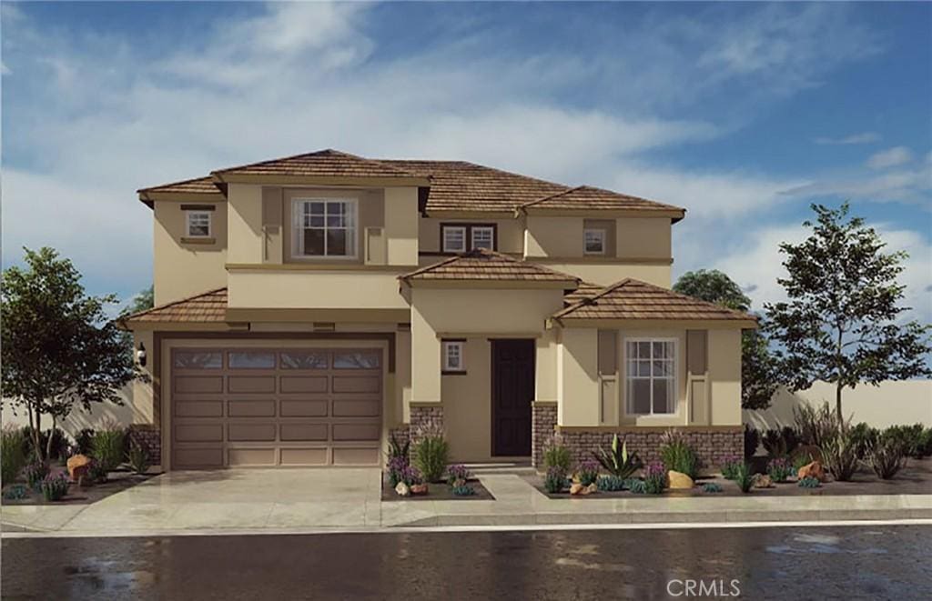 mediterranean / spanish home featuring a garage, concrete driveway, brick siding, and stucco siding