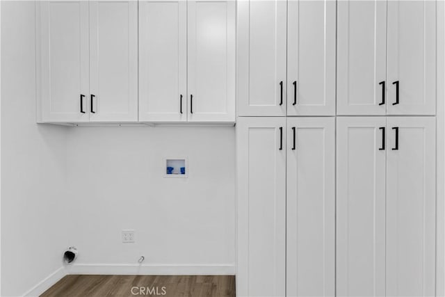 laundry area with hookup for a washing machine, wood finished floors, baseboards, cabinet space, and electric dryer hookup