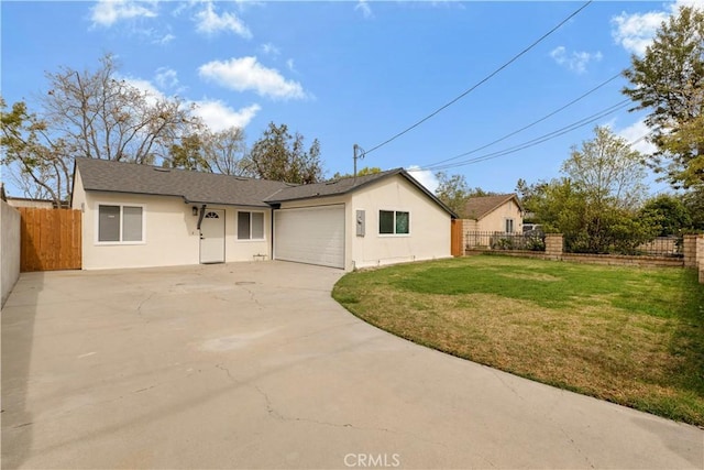 ranch-style home featuring an attached garage, fence, concrete driveway, and stucco siding