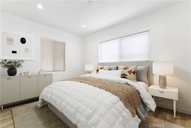 bedroom featuring baseboards, light wood finished floors, and recessed lighting