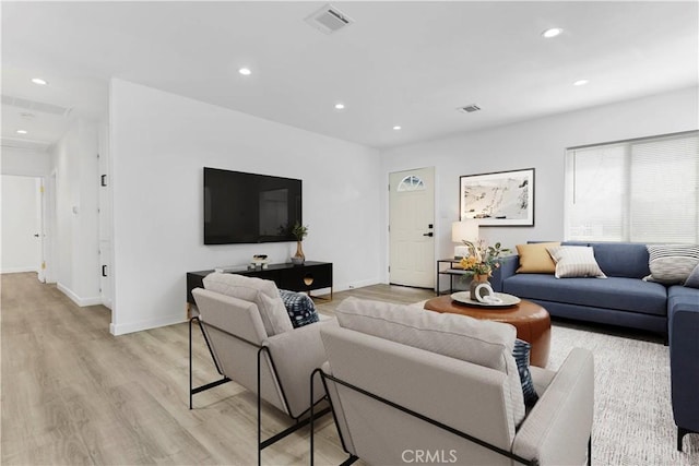 living room with light wood finished floors, visible vents, and recessed lighting