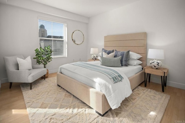 bedroom with baseboards and wood finished floors