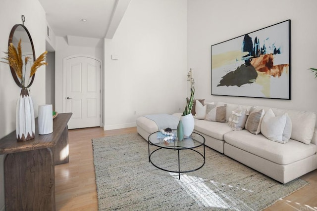 living area featuring light wood-style floors and baseboards