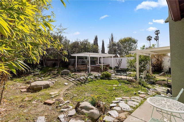 view of yard featuring a patio area, a fenced backyard, and a pergola