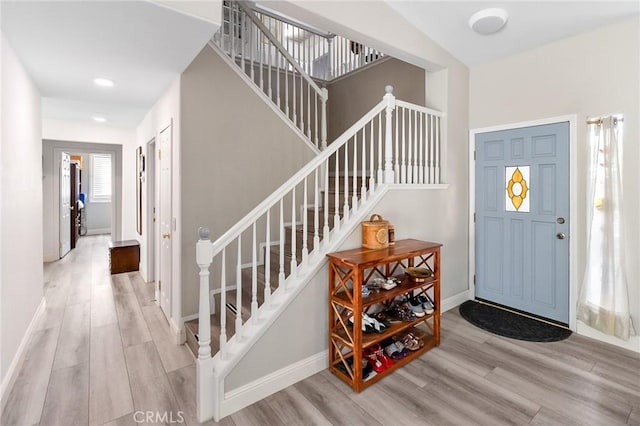 entrance foyer with baseboards and wood finished floors