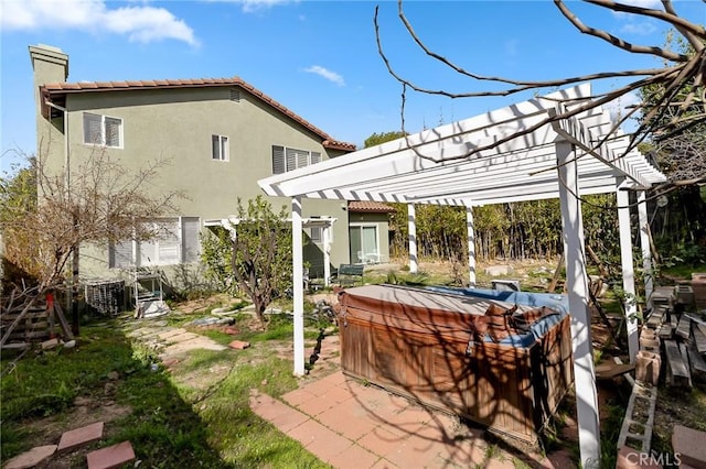 exterior space featuring a pergola and a hot tub