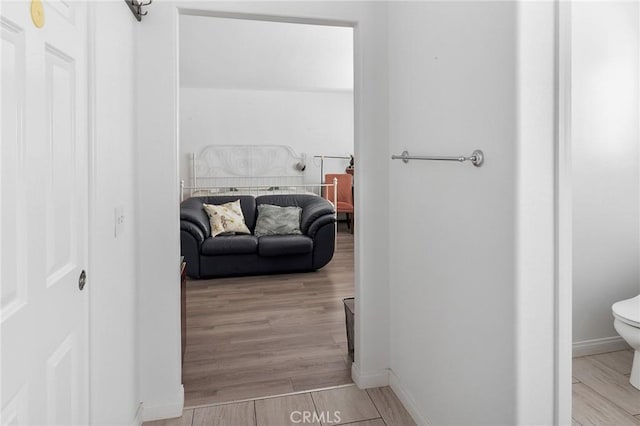 interior space featuring baseboards and wood finished floors