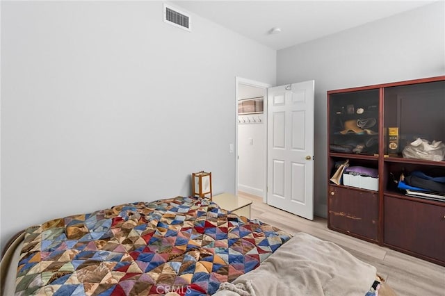 bedroom featuring light wood-type flooring and visible vents