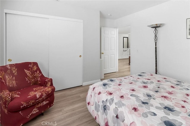 bedroom featuring a closet and light wood finished floors