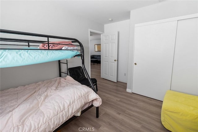 bedroom featuring a closet and wood finished floors