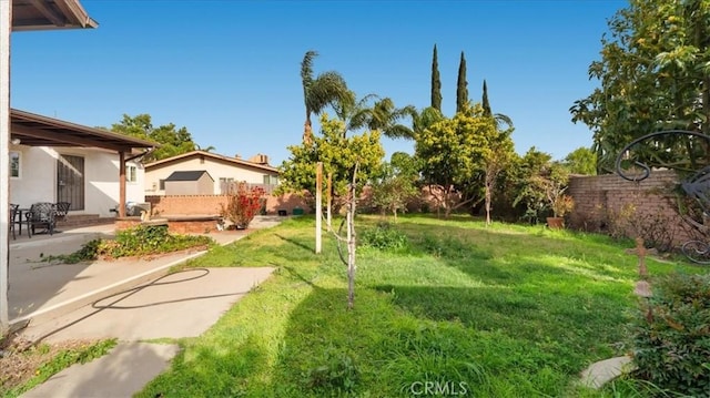 view of yard featuring a patio area and fence