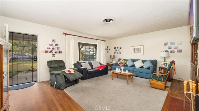 living room with wood finished floors and visible vents