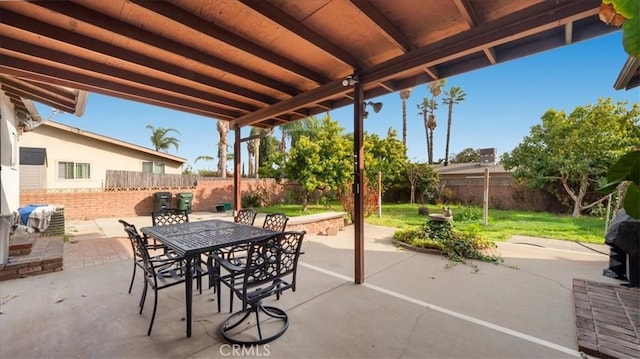 view of patio with a fenced backyard and outdoor dining area