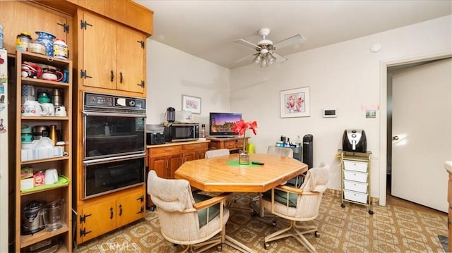 kitchen with brown cabinetry, dobule oven black, and ceiling fan