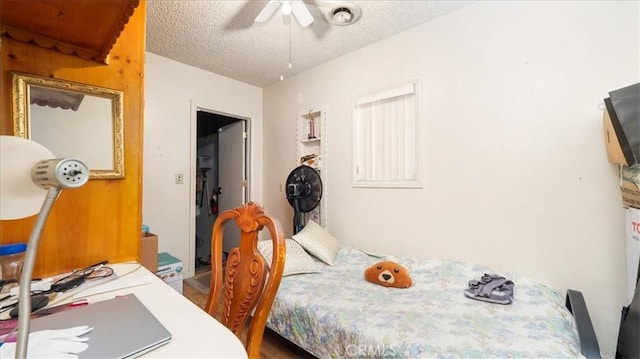 bedroom featuring a textured ceiling and ceiling fan