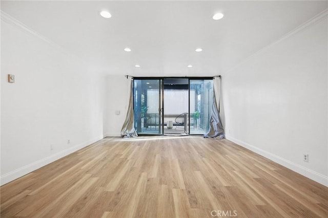 empty room with baseboards, a wall of windows, crown molding, light wood-style floors, and recessed lighting