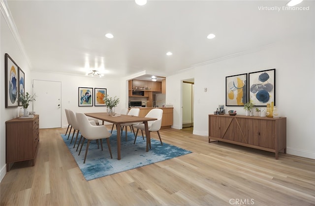 dining space with ornamental molding, recessed lighting, light wood-style flooring, and baseboards