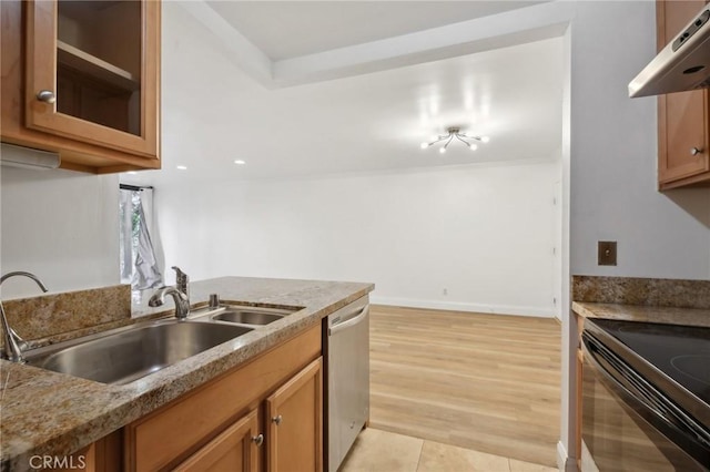 kitchen with brown cabinetry, dishwasher, black electric range, under cabinet range hood, and a sink