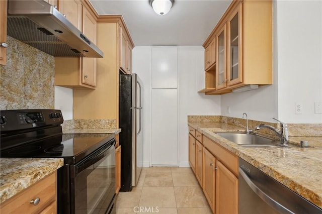 kitchen with light tile patterned floors, under cabinet range hood, stainless steel appliances, a sink, and glass insert cabinets