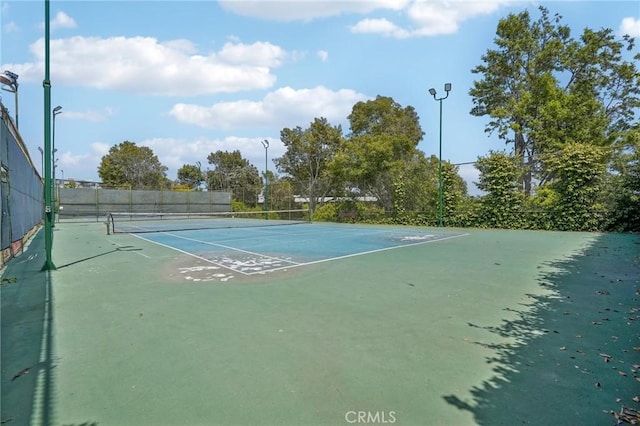 view of tennis court with fence